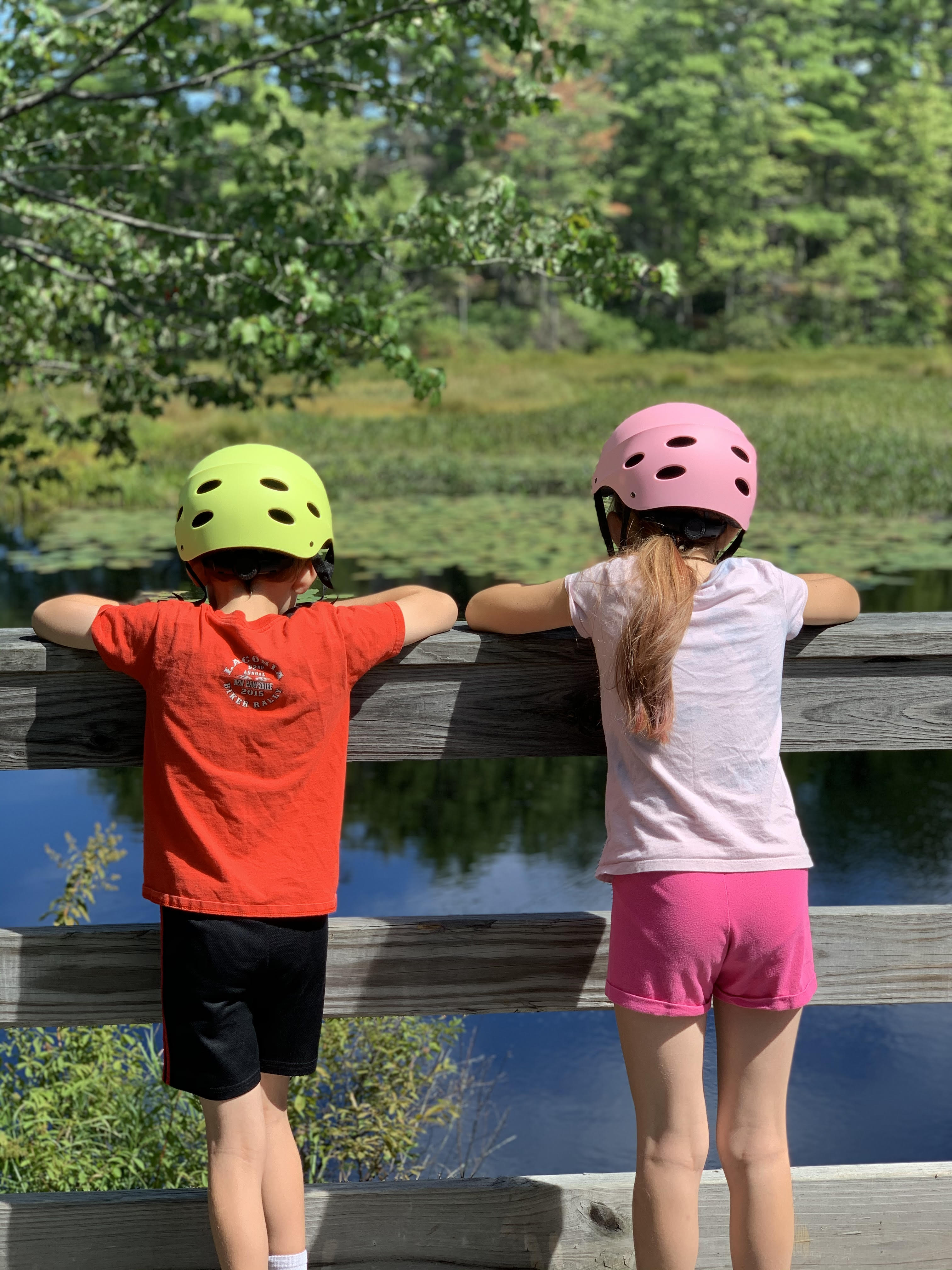 boy and girl on bridge wearing helmets